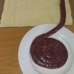 Laying out the wors on the pastry.
