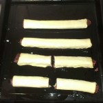 Raw sausage rolls almost ready for the oven.